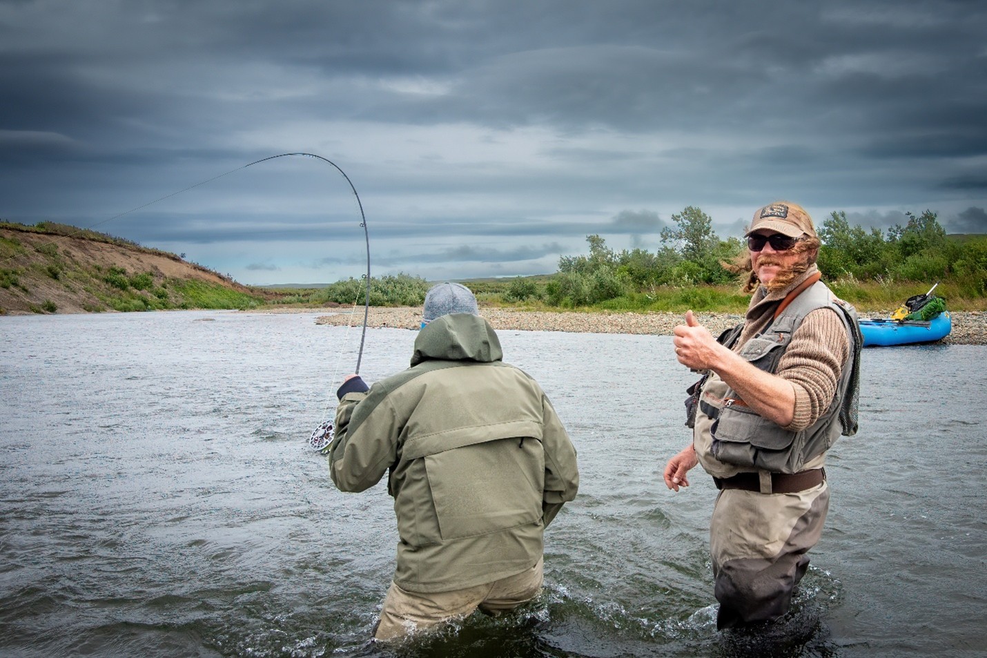 Angler with bent rod in river